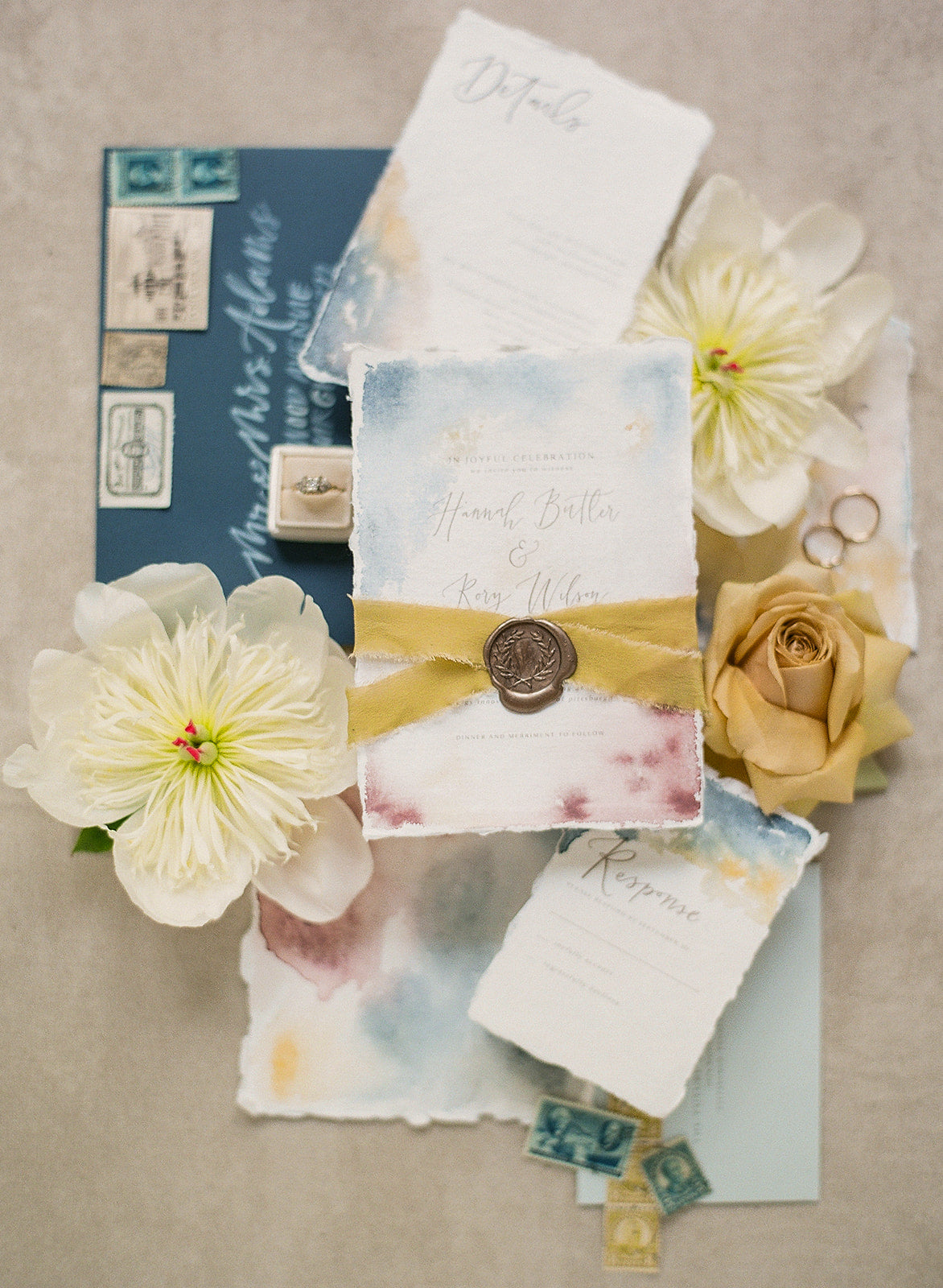 watercolor wedding invitation with calligraphy, wax seal, silk ribbon, and handmade paper